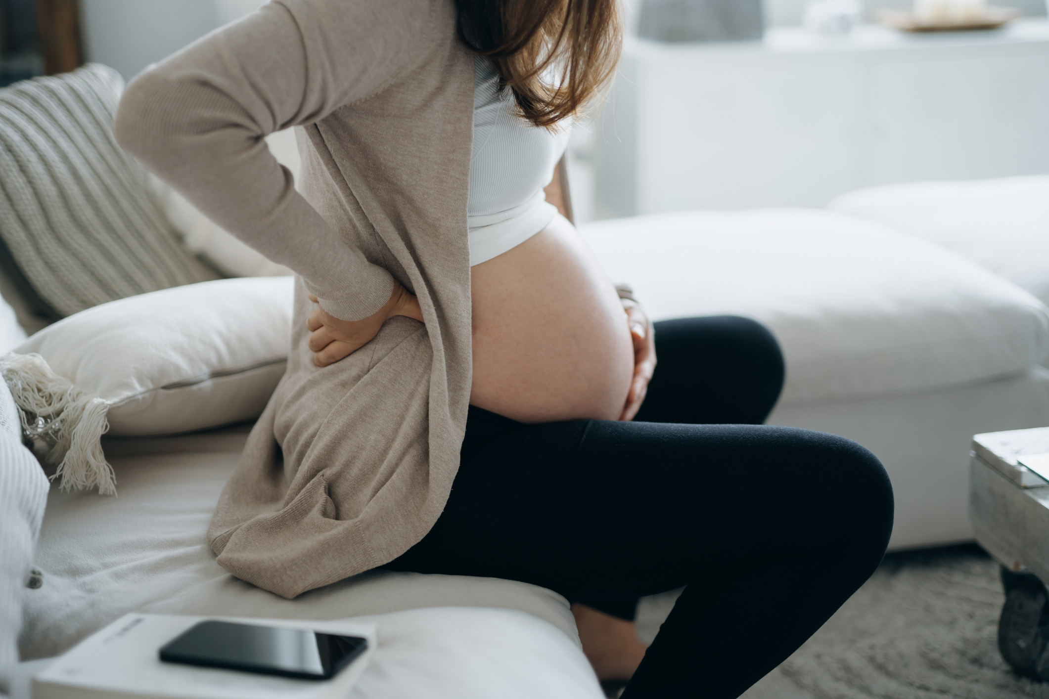 pregnant woman touching her belly